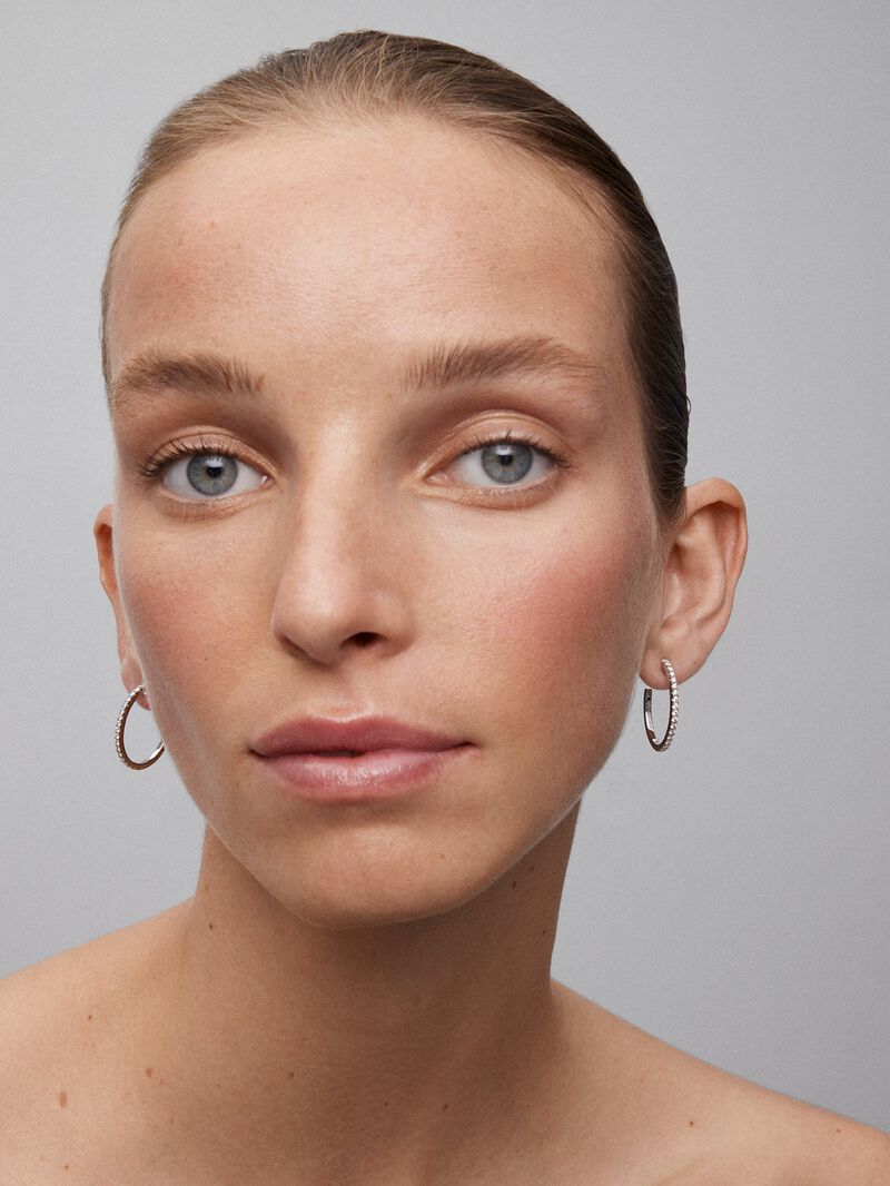 Thin hoop earrings made of 18K white gold with diamonds. image number 5