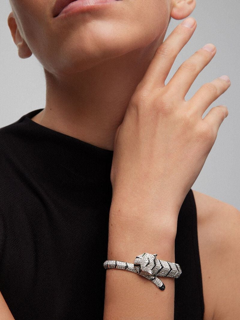 Rigid 18K white gold bracelet with 747 brilliant-cut white diamonds with a total of 8.17 cts, 241 brilliant-cut black diamonds with a total of 1.49 cts and 2 trapezoid-cut emeralds with a total of 0.13 tiger shaped cts image number 1