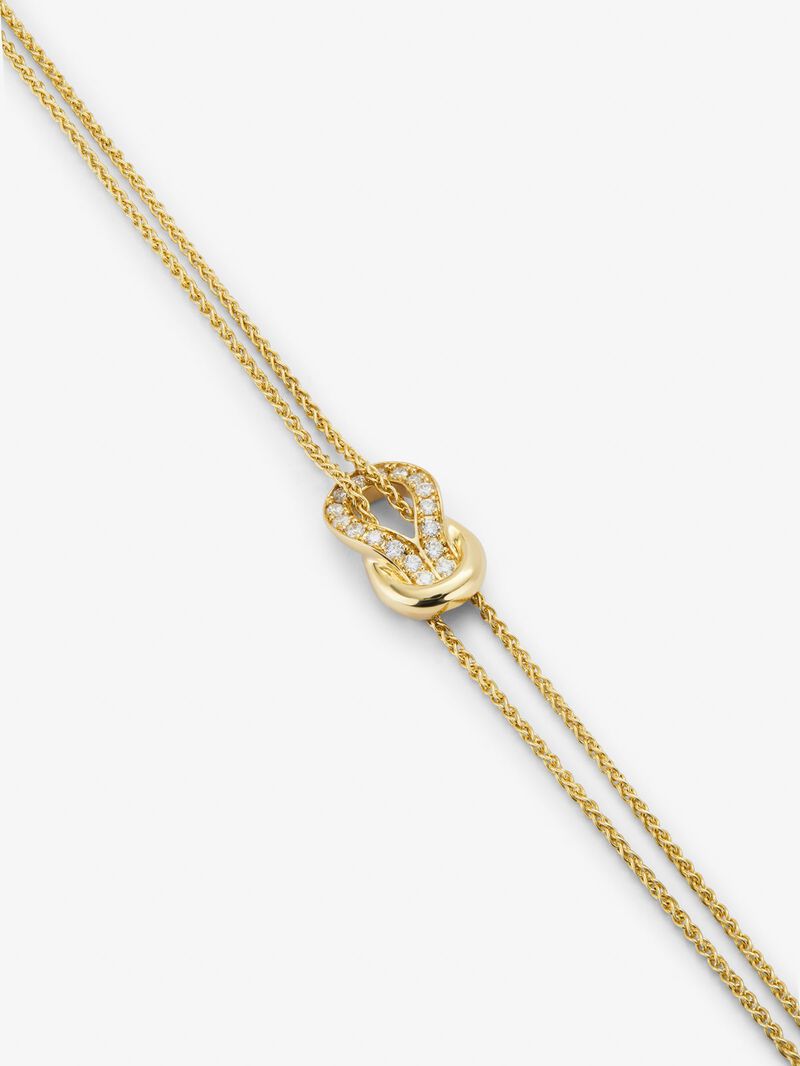 18K yellow gold bracelet with 17 brilliant-cut diamonds with a total of 0.15 cts and a knot shape image number 2