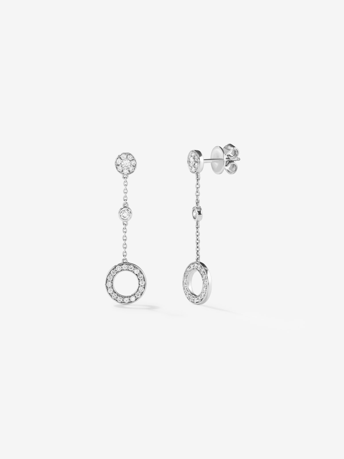 Long 18kt white gold chain earrings with circular diamond motifs.