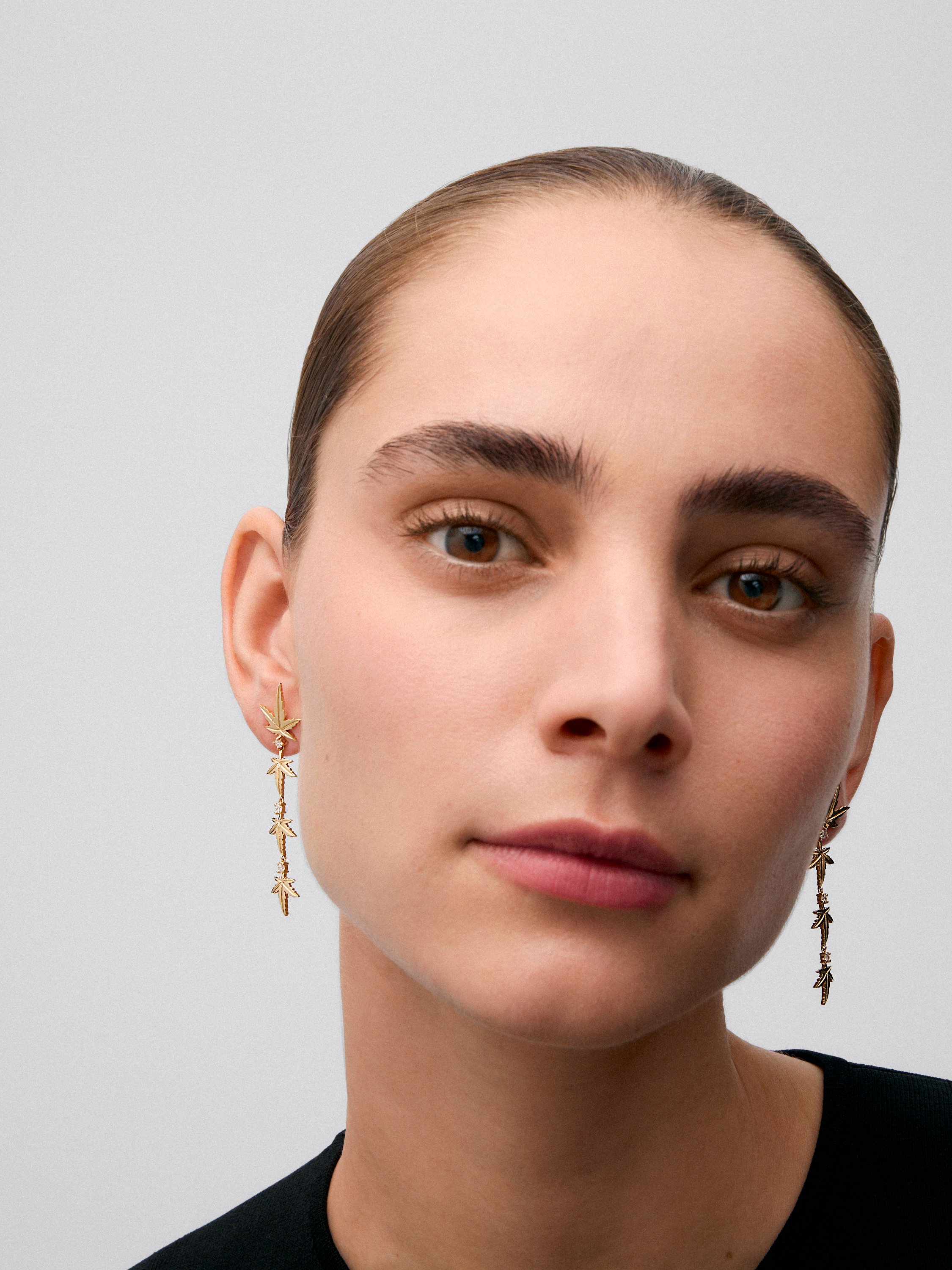 18K yellow gold earrings with six brilliant-cut diamonds totaling 0.29 cts, in a maple leaf design