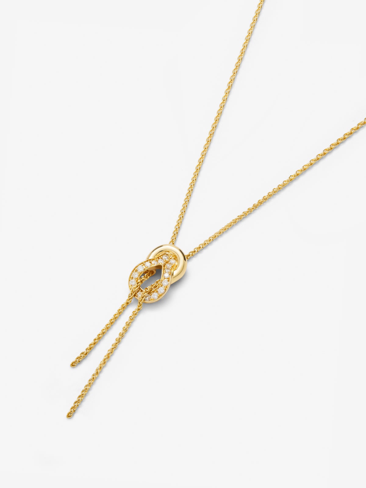Colgante de oro amarillo de 18K con 26 diamantes en talla brillante con un total de 0,16 cts y forma de nudo