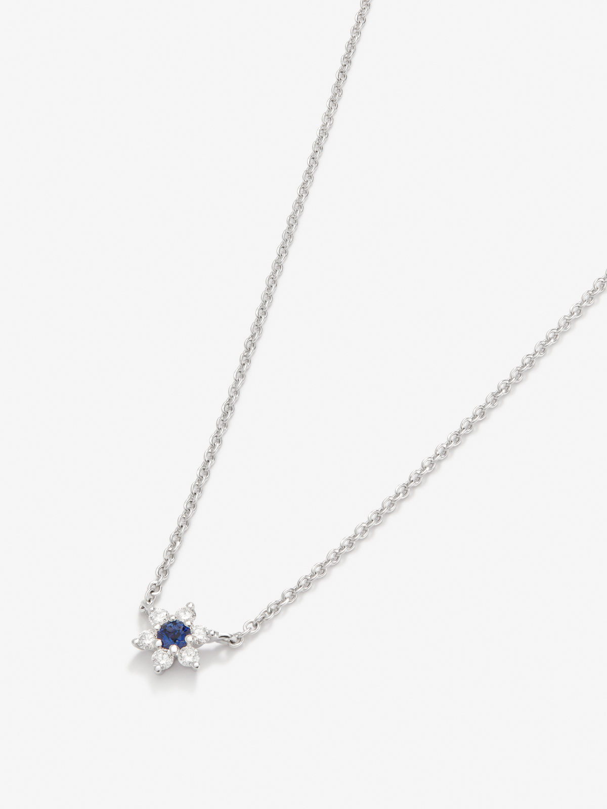 18K white gold pendant with blue sapphire in a brilliant size of 0.1 cts and white diamonds in bright size of 0.12 cts in star -shaped form