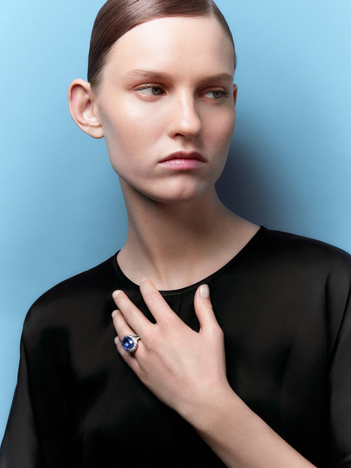 18kt white gold ring with royal blue sapphire, oval cut of 12.64 carats, and diamonds.