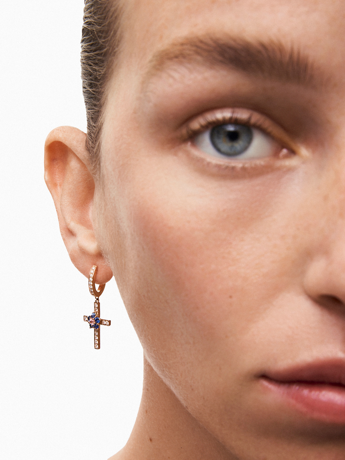 18kt rose gold hoop earrings with diamond cross and flower with sapphires.