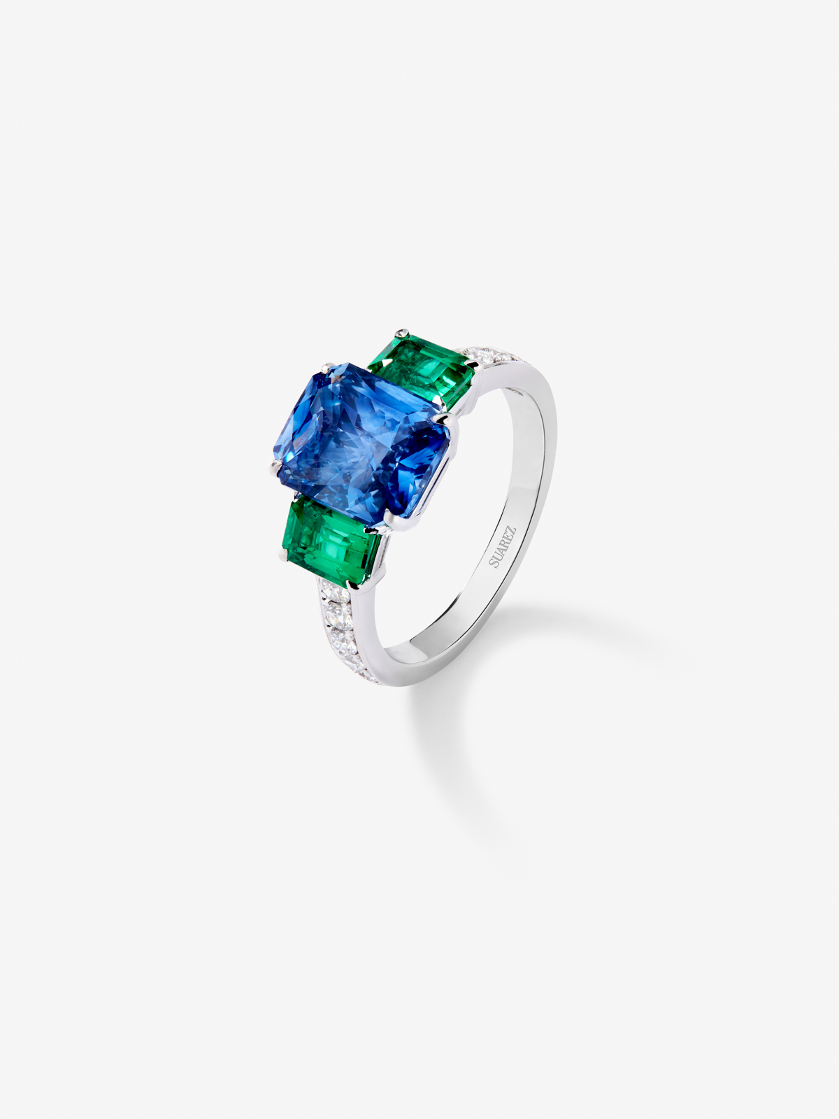 18K White Gold Tiego Ring with blue sapphire in 3.6 cts emerald size, green emeralds in octagonal size 1.12 cts and white diamonds in bright size of 0.073 cts