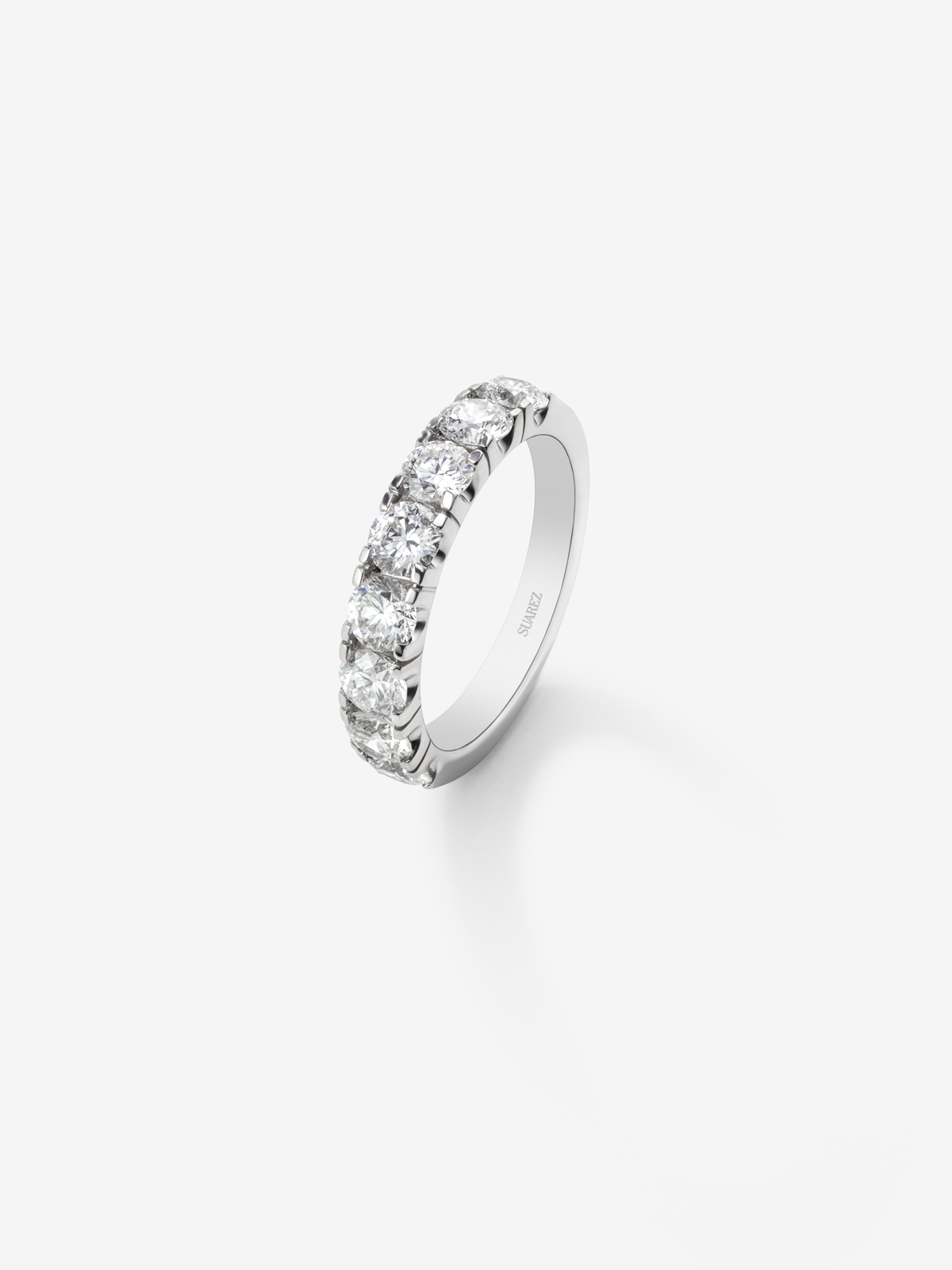18K white gold half-eternity engagement ring with claw-set diamonds.
