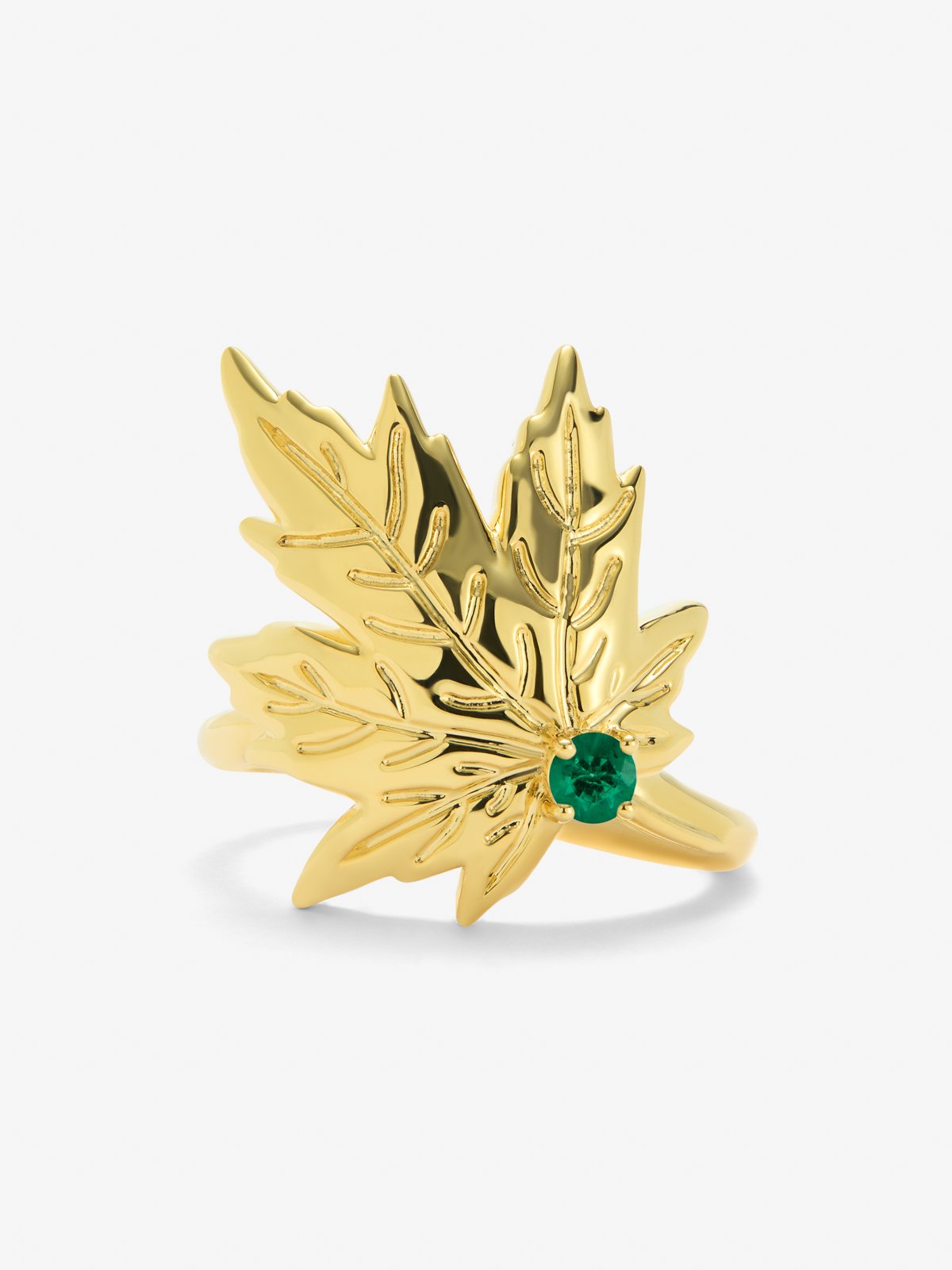 Anillo de oro amarillo de 18K con esmeralda central en talla brillante de 0,19 cts y forma de hoja de arce
