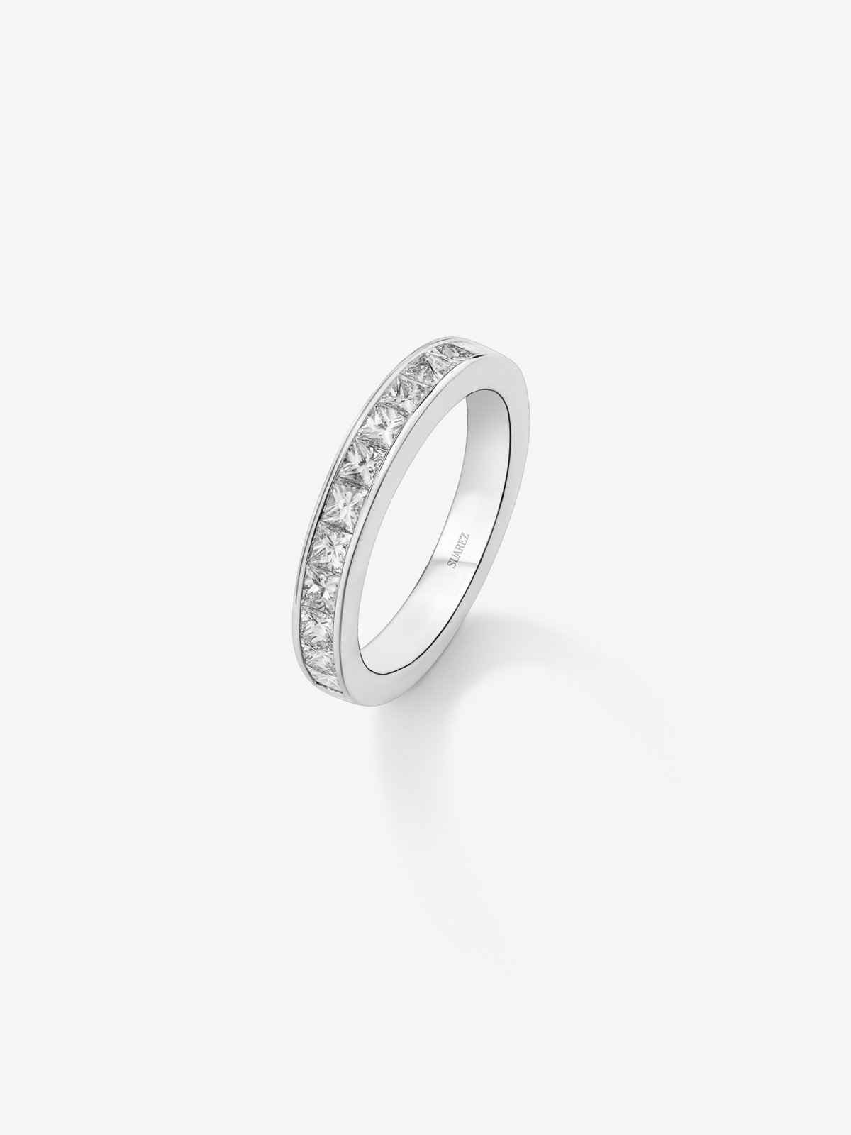 18K white gold half eternity engagement ring with princess cut diamonds on a rail.