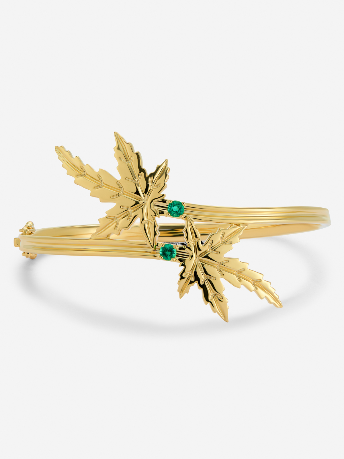 18K yellow gold bracelet with two brilliant-cut emeralds totaling 0.23 cts, in a maple leaf design.