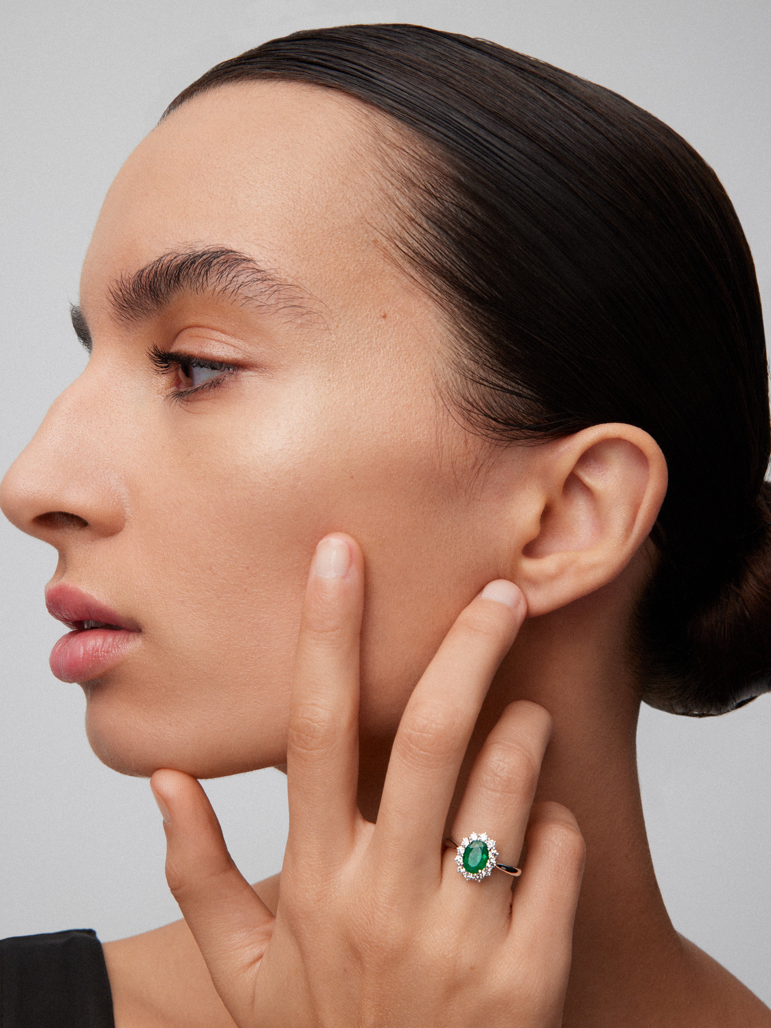 18K white gold ring with oval-cut emerald of 0.77 cts and 12 brilliant-cut diamonds with a total of 0.24 cts