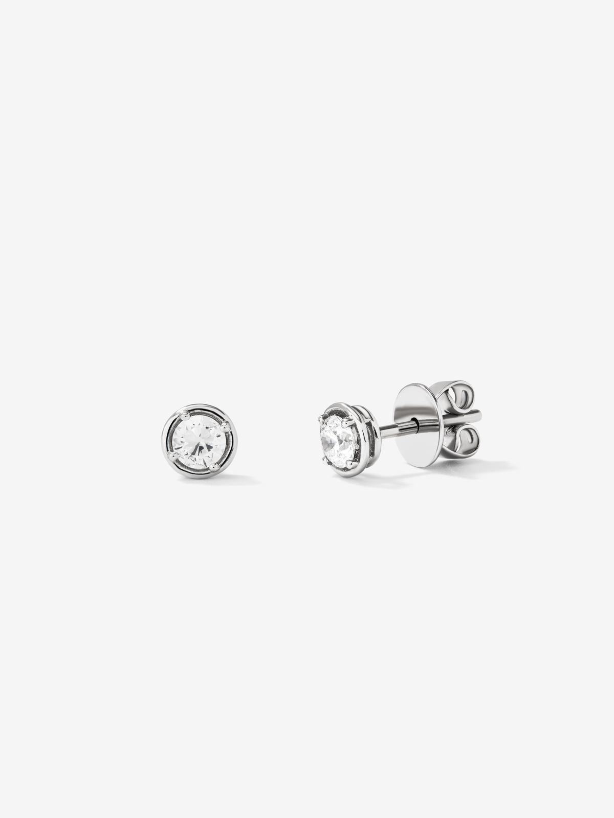 18K white gold earrings with solitary diamond.