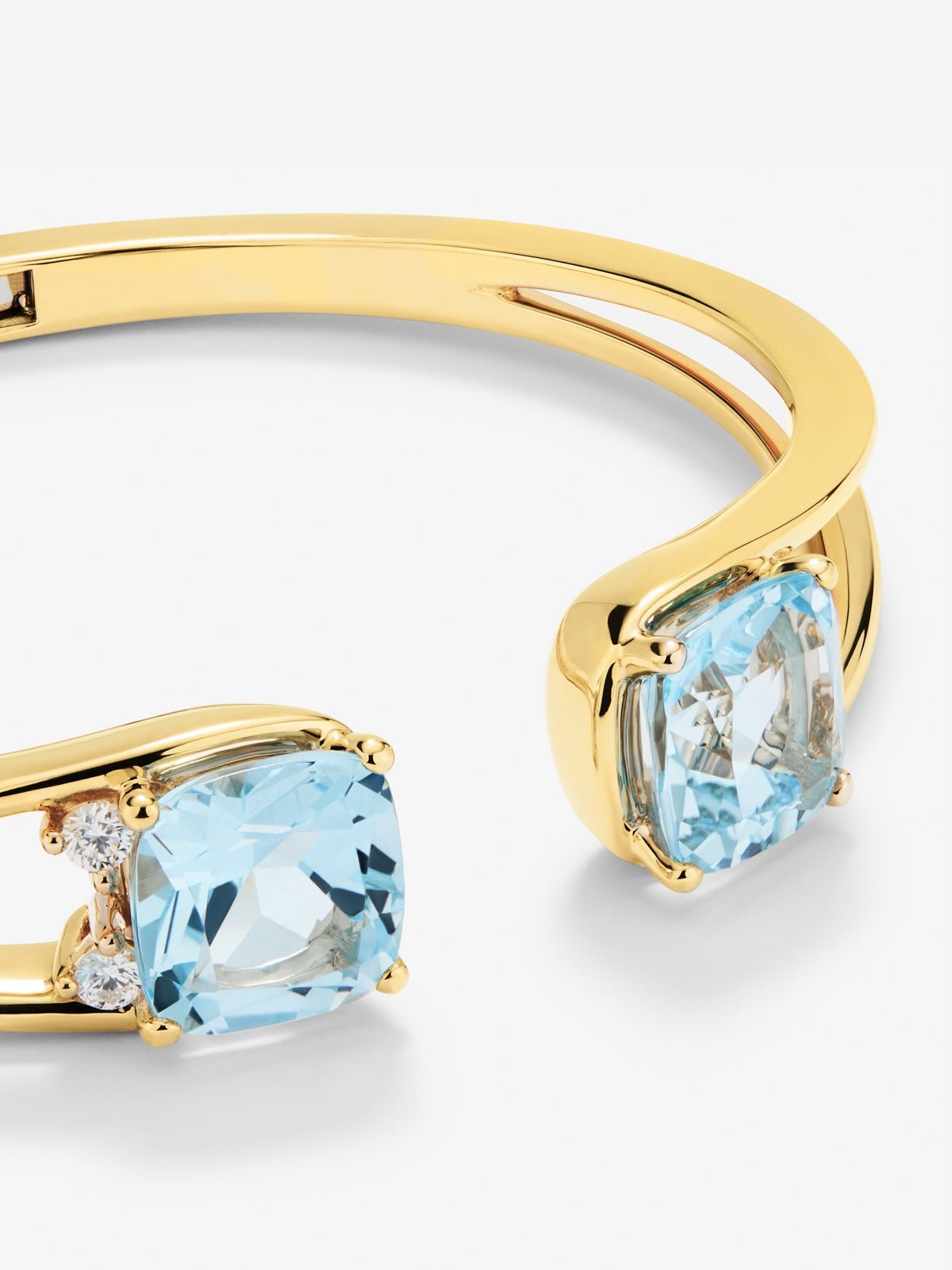 Rigid 18K yellow gold bracelet with 2 sky blue topazes in cushion cut with a total of 0.12 cts